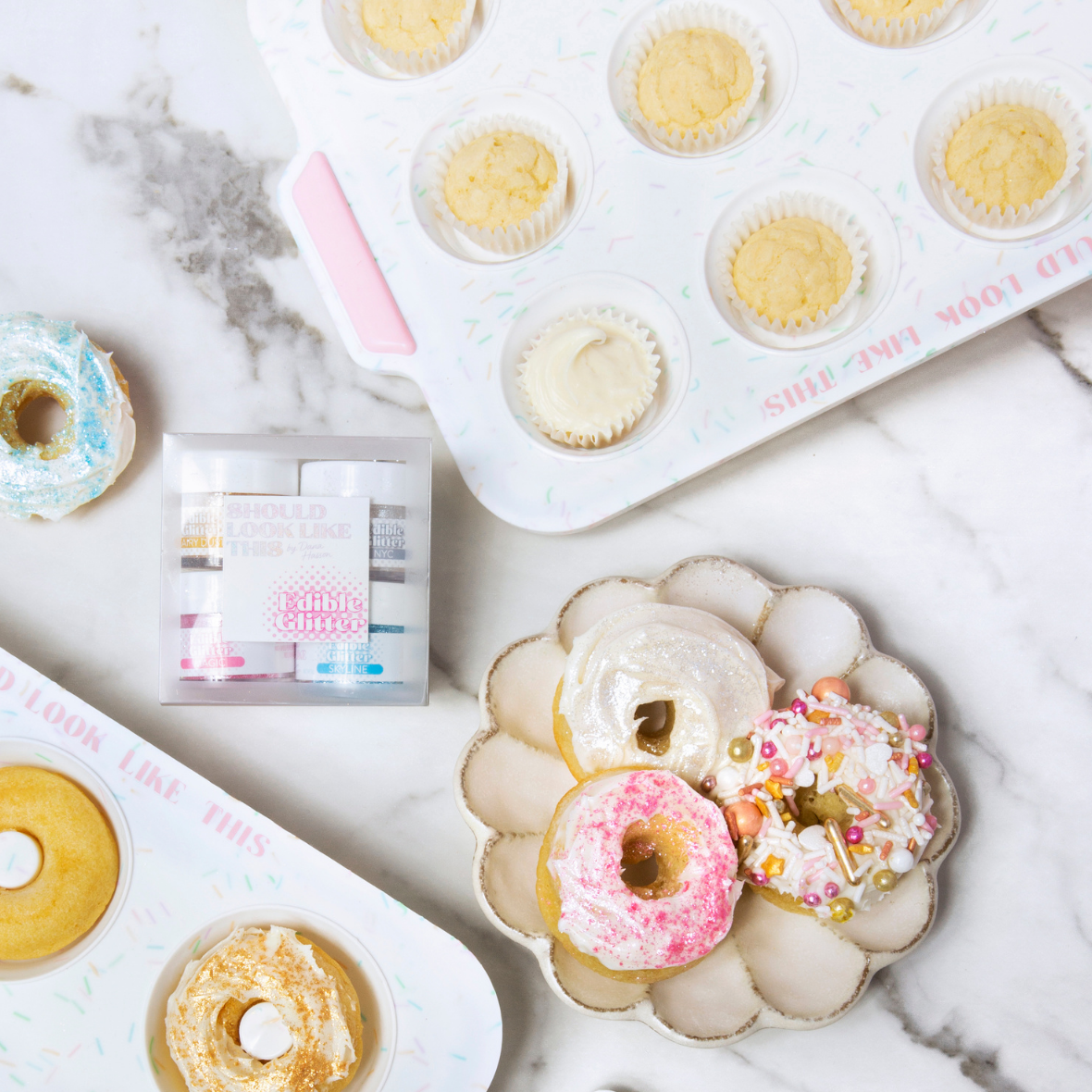 photo of mini muffin pan, donut mold, edible glitter, and donuts on countertop